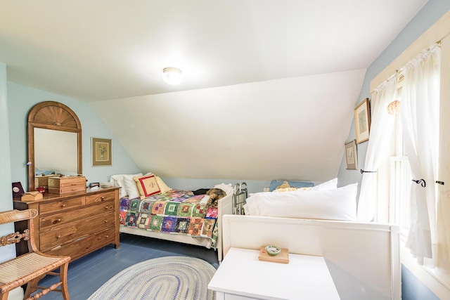 bedroom with vaulted ceiling and dark wood-type flooring