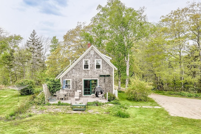 back of property with a wooden deck and a yard