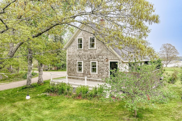 view of side of property with a yard