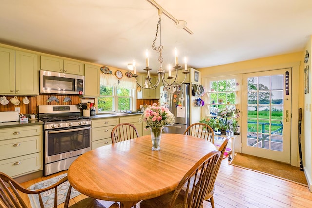 dining room featuring sink and light wood-type flooring