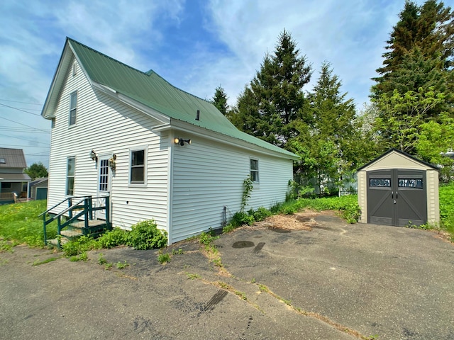 view of property exterior with a garage and an outdoor structure