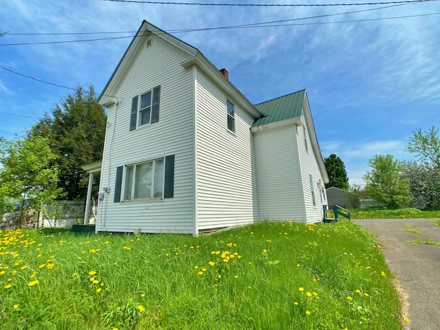 view of side of home featuring a yard