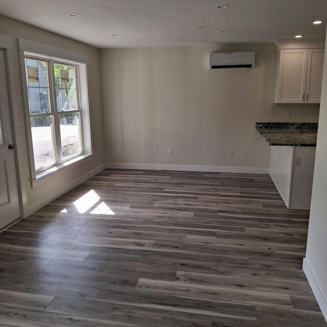 5 Apex Dr Unit 1, Westbrook, ME 04092 - unfurnished dining area with an AC wall unit, recessed lighting, baseboards, and dark wood-style flooring