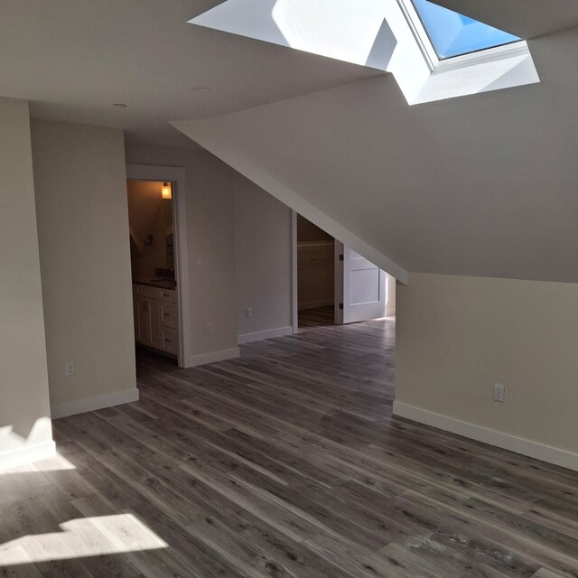 5 Apex Dr Unit 1, Westbrook, ME 04092 - bonus room featuring a skylight, dark wood-style flooring, baseboards, and lofted ceiling