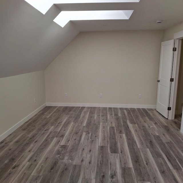 5 Apex Dr Unit 1, Westbrook, ME 04092 - additional living space with a skylight, vaulted ceiling, wood finished floors, and baseboards