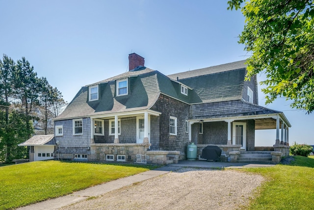 93 Beach Ave, Kennebunk, ME 04043 - view of front of house with covered porch, a front yard, a gambrel roof, and a chimney