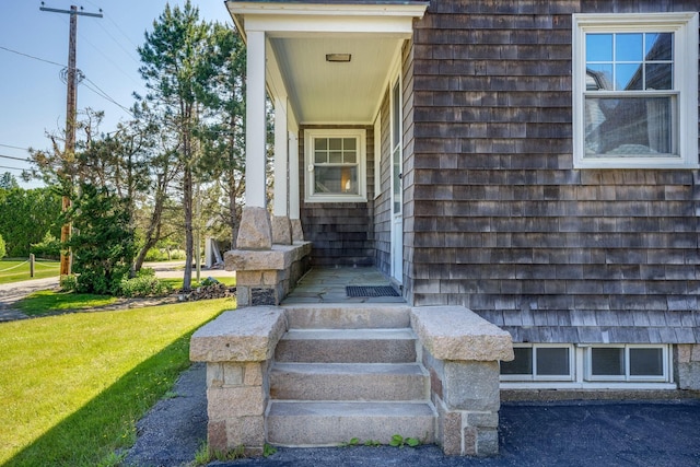 property entrance with a lawn