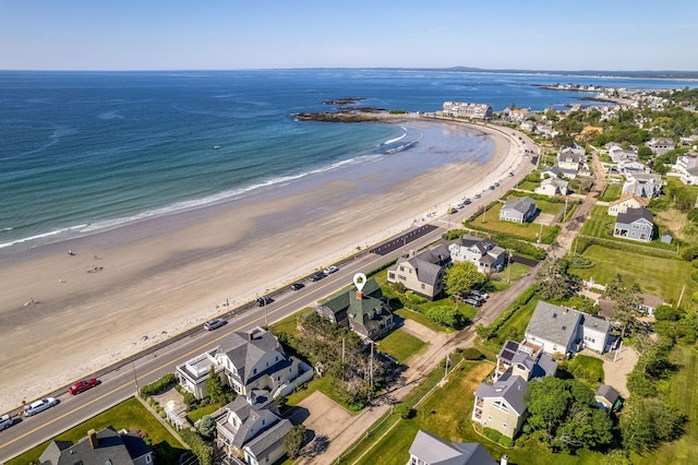 drone / aerial view with a water view and a beach view