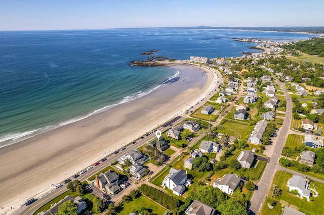 birds eye view of property featuring a water view and a beach view