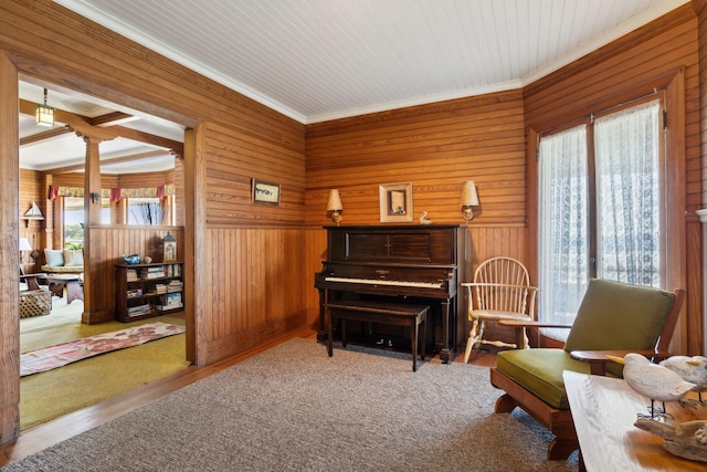 93 Beach Ave, Kennebunk, ME 04043 - living area with crown molding, wood walls, wood finished floors, and decorative columns