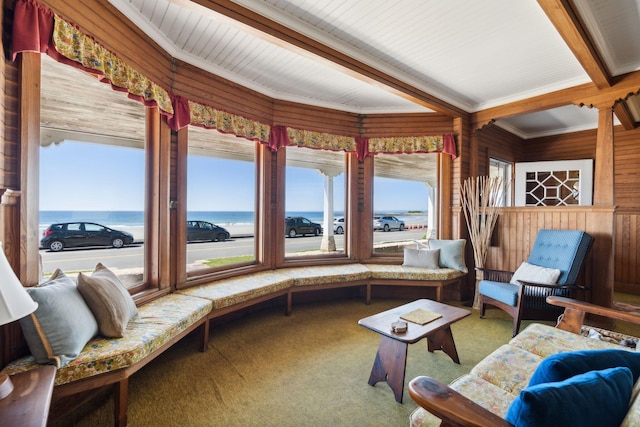 sunroom / solarium featuring a water view and beam ceiling