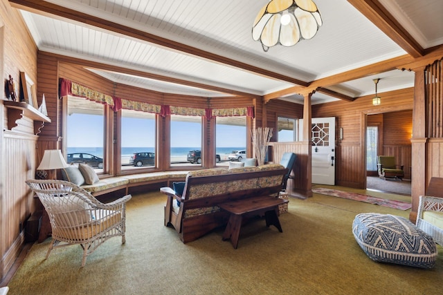 93 Beach Ave, Kennebunk, ME 04043 - carpeted living area featuring beamed ceiling, wooden walls, a water view, and crown molding