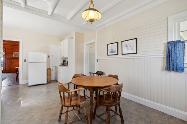 dining area featuring beam ceiling