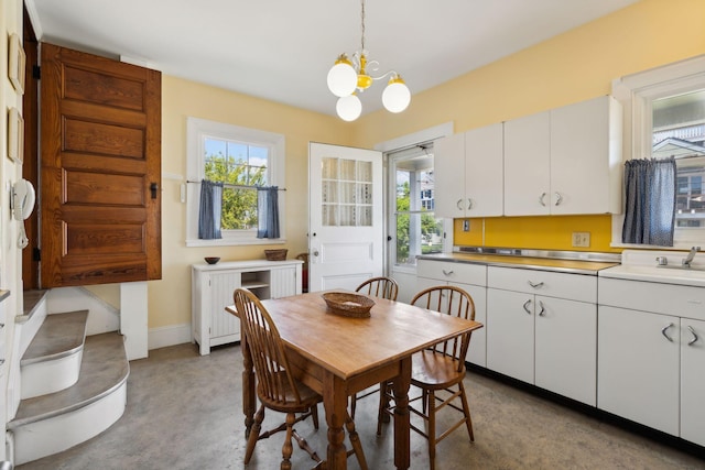 93 Beach Ave, Kennebunk, ME 04043 - dining room with a chandelier and plenty of natural light