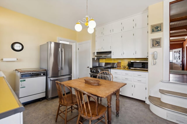 kitchen with appliances with stainless steel finishes, white cabinets, an inviting chandelier, and decorative light fixtures