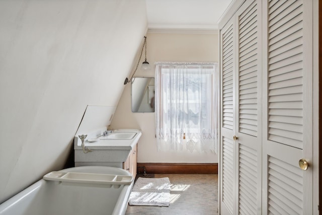 93 Beach Ave, Kennebunk, ME 04043 - bathroom with a closet, vanity, and crown molding