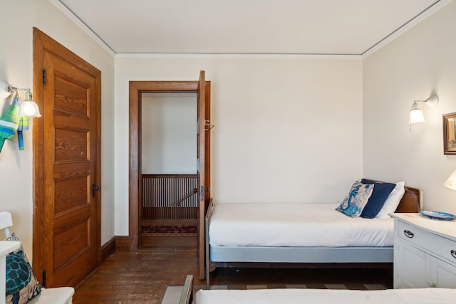 bedroom featuring ornamental molding and dark wood-type flooring