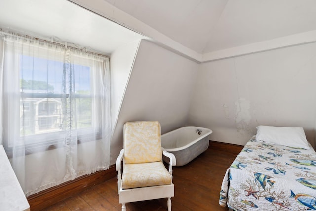 bedroom featuring dark hardwood / wood-style flooring and vaulted ceiling