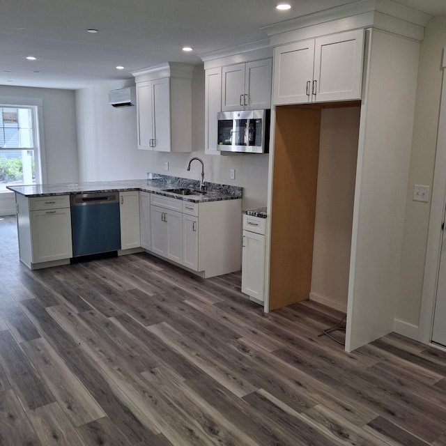 7 Apex Dr Unit 2, Westbrook, ME 04092 - kitchen featuring appliances with stainless steel finishes, a sink, a wall unit AC, a peninsula, and dark wood-style flooring