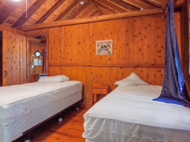 bedroom featuring wood-type flooring, vaulted ceiling with beams, wooden walls, and wood ceiling