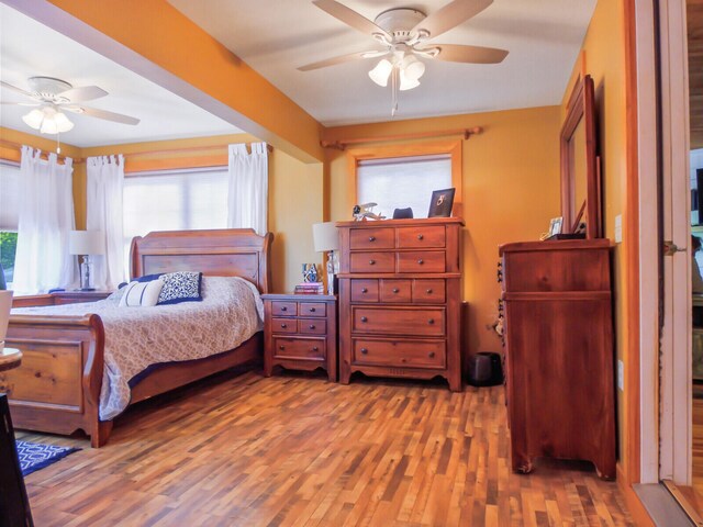 bedroom with hardwood / wood-style floors and ceiling fan