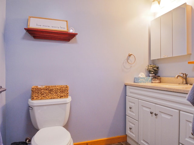 bathroom featuring toilet and vanity