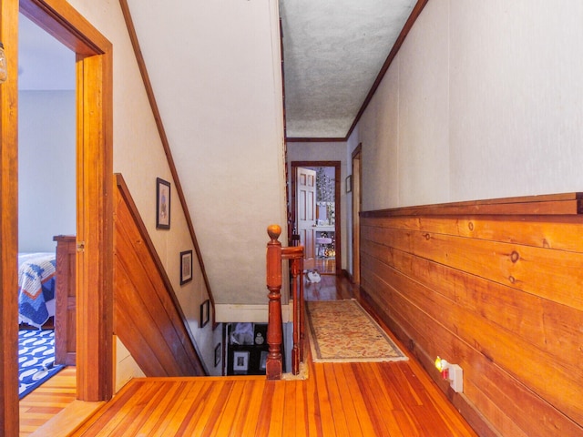 hall featuring wood-type flooring and crown molding