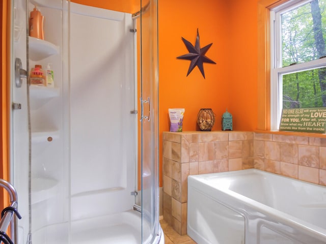 bathroom with tile walls and plus walk in shower