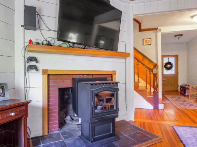 room details with a wood stove and wood-type flooring