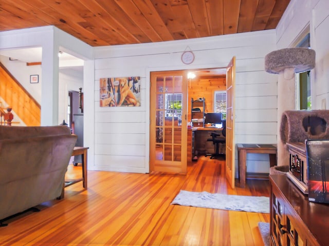 living room featuring wood walls, wood ceiling, and wood-type flooring