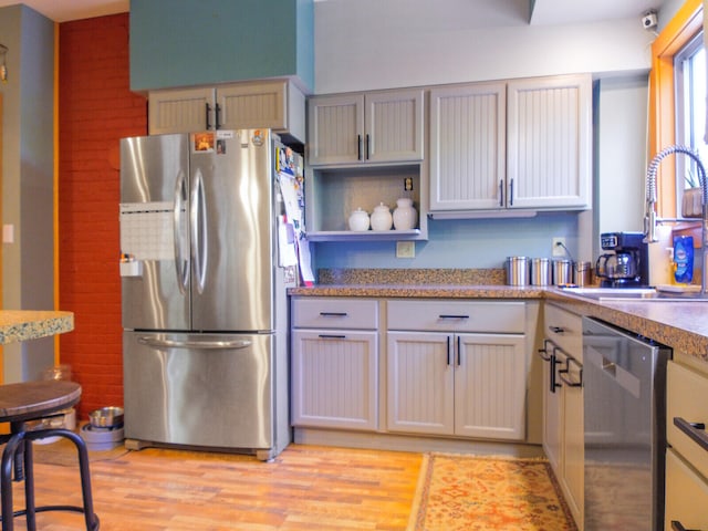 kitchen featuring sink, light wood-type flooring, and stainless steel appliances