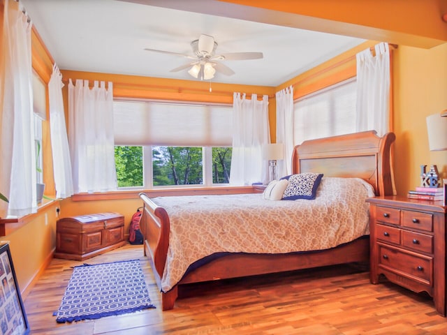 bedroom with light wood-type flooring and ceiling fan