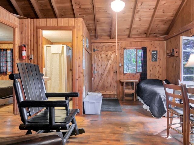 interior space with a wealth of natural light, wooden walls, lofted ceiling, and hardwood / wood-style flooring