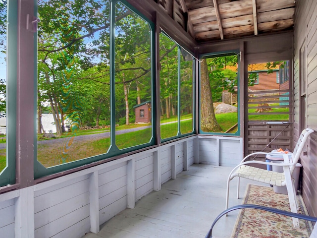 unfurnished sunroom featuring wooden ceiling