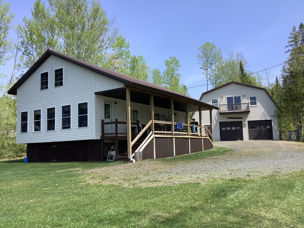 13 Goss Brook Ln, Winterville Plt, ME 04739 - rear view of house with a lawn, a porch, and a garage