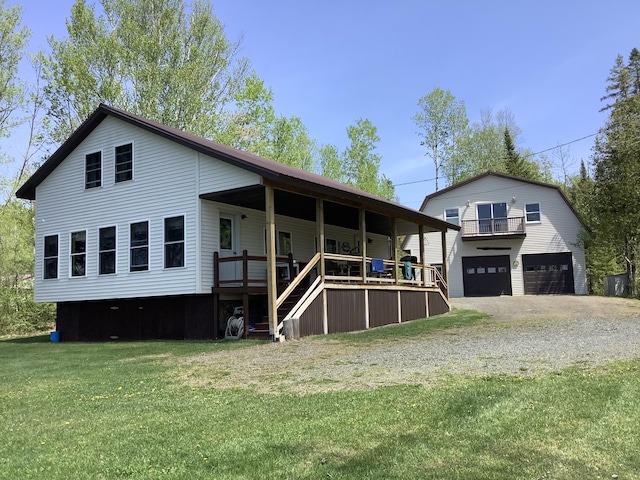 rear view of house with a lawn, a porch, and a garage