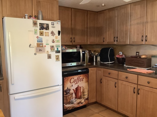 kitchen with ceiling fan, white fridge, and light tile patterned floors