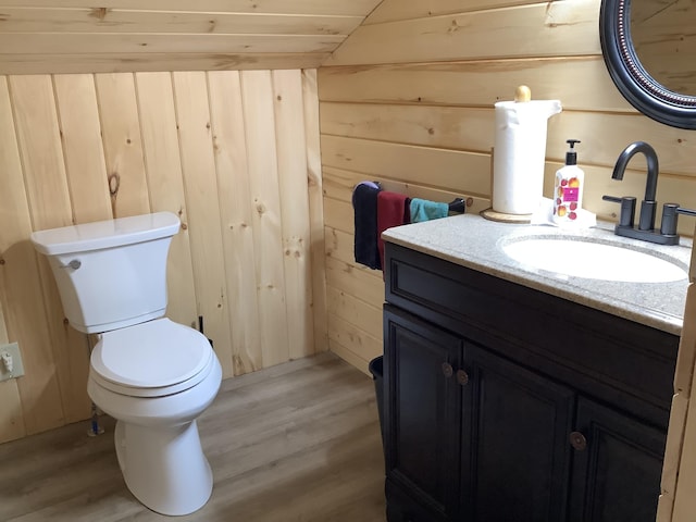 bathroom with hardwood / wood-style floors, vanity, wood walls, and wood ceiling