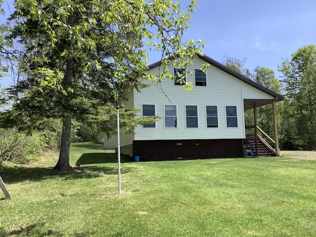 view of side of property with a lawn