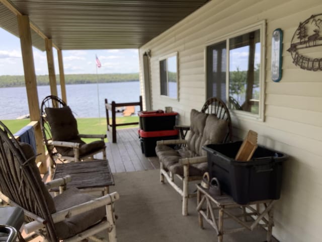 exterior space with covered porch and a water view