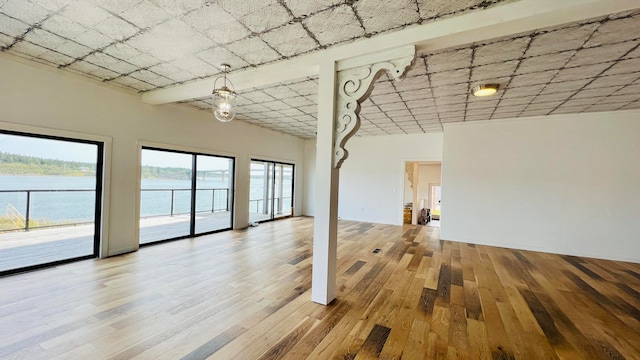 interior space featuring a water view and hardwood / wood-style floors