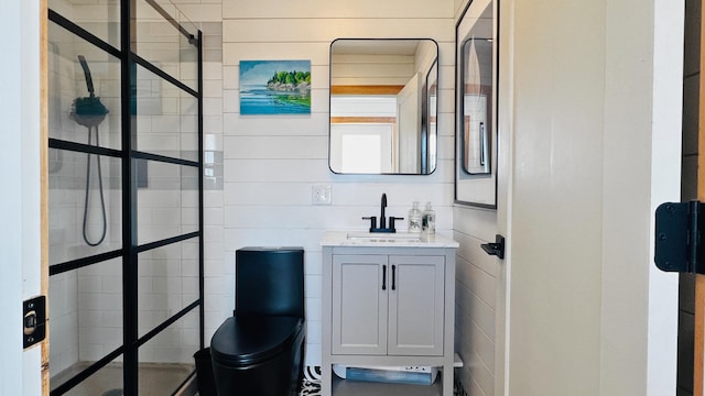 bathroom featuring a tile shower, vanity, and toilet