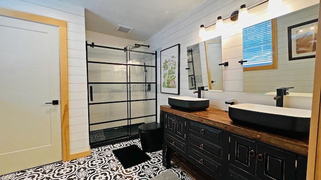 bathroom with tiled shower, vanity, and wooden walls