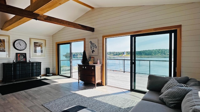 living room with light hardwood / wood-style flooring, lofted ceiling with beams, wooden walls, and a water view