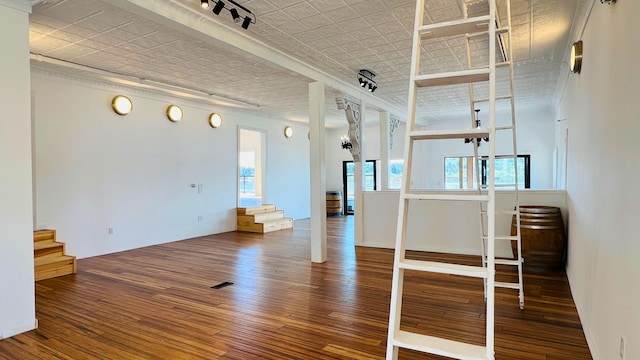 unfurnished room featuring hardwood / wood-style floors and track lighting