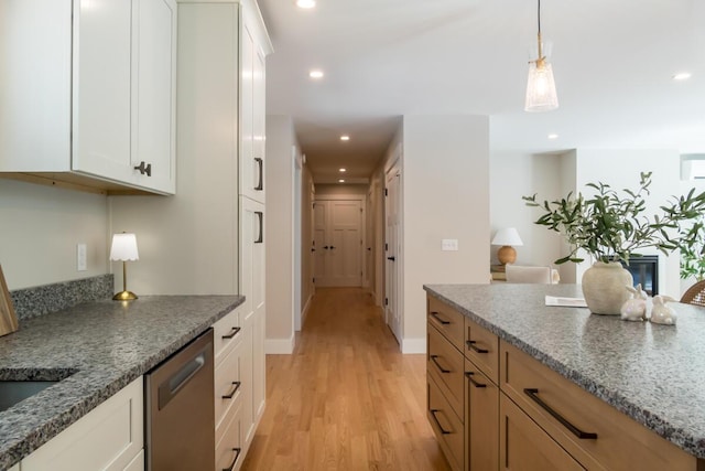 kitchen featuring stone countertops, stainless steel dishwasher, recessed lighting, white cabinets, and light wood finished floors