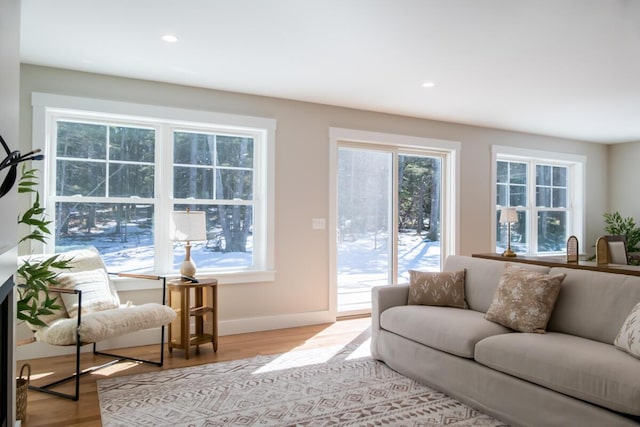 living room featuring recessed lighting, baseboards, and wood finished floors