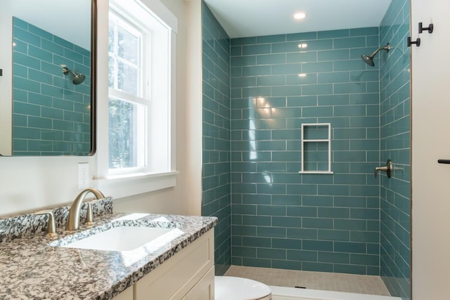 bathroom featuring a shower stall, vanity, and toilet