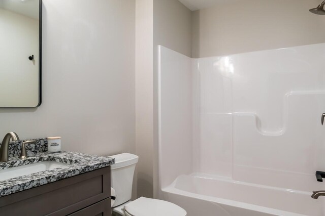 bathroom with shower / bathtub combination, toilet, and vanity