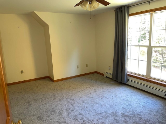 interior space featuring baseboard heating, ceiling fan, light carpet, and plenty of natural light